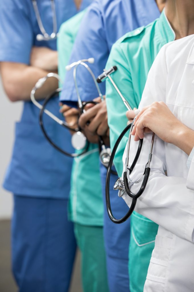 partial view of group of medical workers with equipment in laboratory